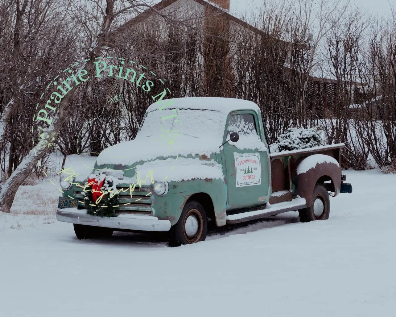 an old truck with a christmas wreath on the back of it