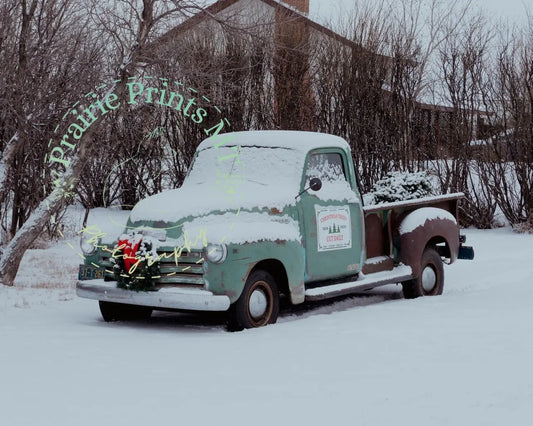 an old truck with a christmas wreath on the back of it